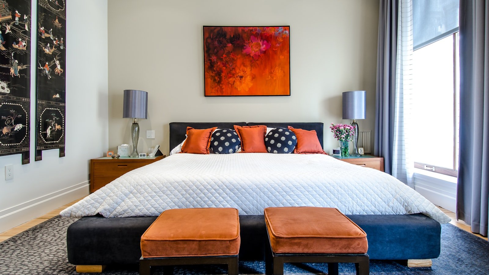 Modern bedroom with neatly made queen bed for couples